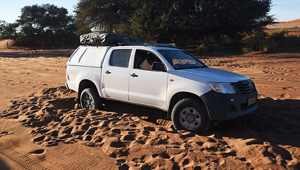 Fully equipped 4x4 camper parked on a gravel road in Namibia