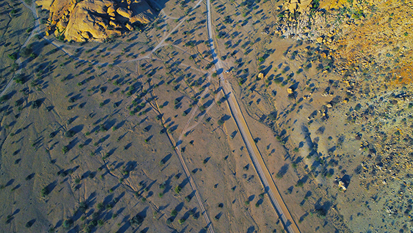 A quiet gravel road stretching to the horizon in Namibia