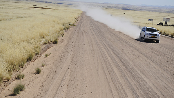 Self-drive route map and open road across the Namibian plains