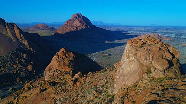 The granite peaks of Spitzkoppe rising from the Namib plains at sunset