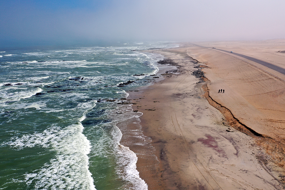 Namib dunes meeting the cold Atlantic at the Skeleton Coast on a foggy morning