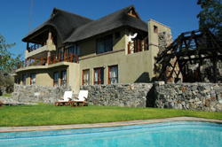 View of another swimming pool area at Epacha Game Lodge, showing the resort's spacious facilities and peaceful setting within the Epacha Private Wildlife Reserve in Aus, Namibia.